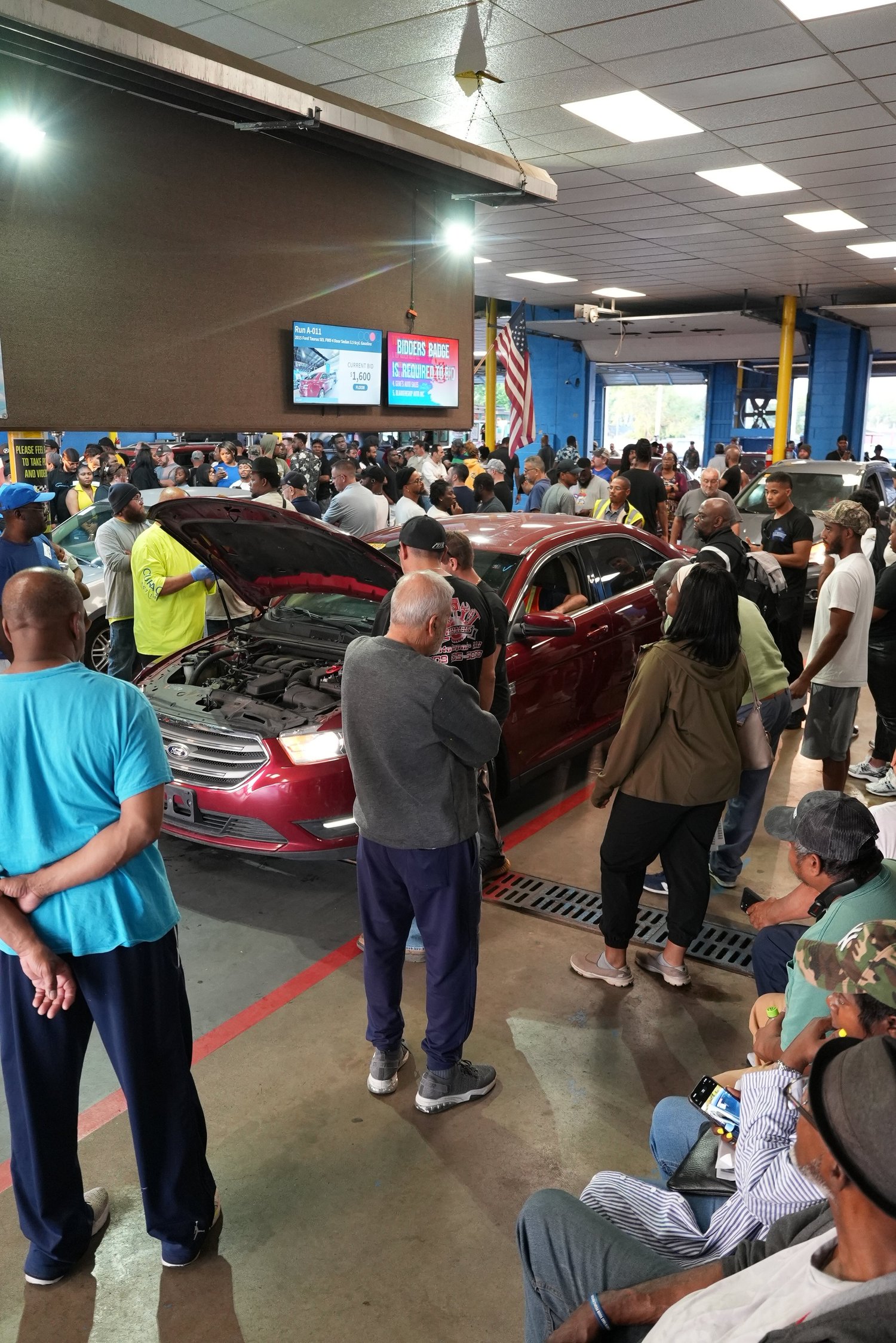 Buyers and vehicles filling the Delaware Auto Exchange auction floor